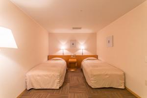 Postel nebo postele na pokoji v ubytování Hotel Landmark Wakayama