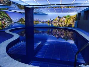 a pool with a view of the water and houses at Hotel Villa Palace in Bakuriani