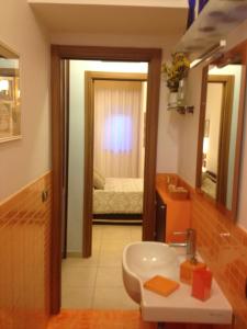 a bathroom with a sink and a bedroom with a bed at Domus Felix in Sorrento