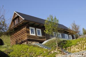 a log house on a hill with stairs at Kacza Chata - willa z jacuzzi in Kraków