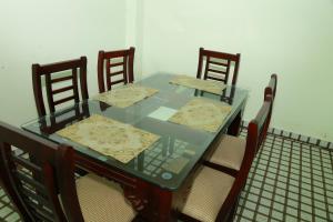 a glass table with four chairs and a table and chairsuggest at The Kissing Mountains in Vagamon