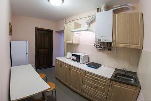 a small kitchen with a sink and a refrigerator at Квартира в центрі по вулиці Вірменська 12 5 дві спальні з двуспальними ліжками є інтернет сама Площа Ринок in Lviv