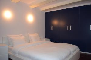 Schlafzimmer mit einem großen Bett und schwarzen Schränken in der Unterkunft Rembrandtplein Bed & Breakfast in Amsterdam