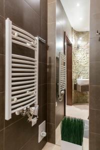 a bathroom with a shower with a sink and a mirror at Apartament Charisma in Zakopane