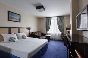 Cama ou camas em um quarto em Statskij Sovetnik Hotel Zagorodnyy