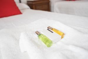two bottles on a white towel on a bed at Apartamento Imperial in Torremolinos