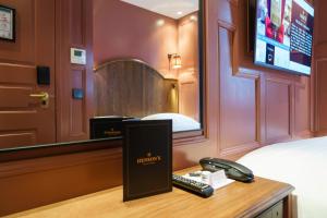 a hotel room with a phone on a desk at Mimi's Hotel Soho in London