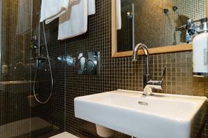 a bathroom with a sink and a shower at Mimi's Hotel Soho in London
