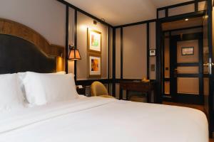a hotel room with a bed and a desk at Mimi's Hotel Soho in London
