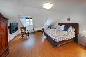 a bedroom with a bed and a television in it at Vakantieappartement Diepstraat in Eijsden