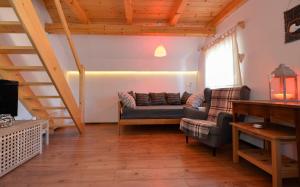 a living room with a couch and a staircase at Rustic House 13 in Bohinj