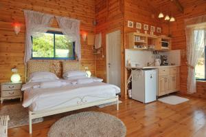 a bedroom with a white bed in a wooden room at Meshi Belavan in Metulla