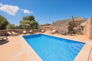 a swimming pool in front of a house at Son Caldés in Llucmajor