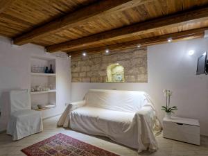 a bedroom with a white bed in a room at Loft 34 in Tarquinia