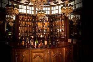 a bar with a lot of bottles of alcohol at Muthu Sovereign Suites & Spa, Limuru Road, Nairobi in Limuru