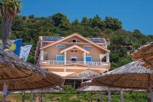 a building with solar panels on top of it at WhiteSands Beach Resort in Paralia Vrachou