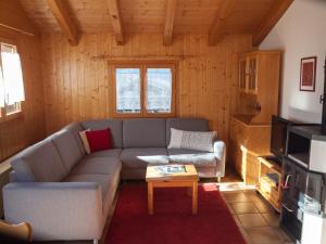 a living room with a couch and a coffee table at Chalet Skilift in Rosswald