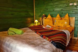 a bedroom with a large bed with yellow pillows at Agroturystyka Żabi Raj Serock - Pułtusk in Pokrzywnica