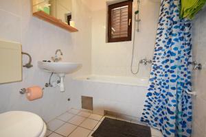a bathroom with a sink and a toilet and a shower at Apartments Vera in Malinska