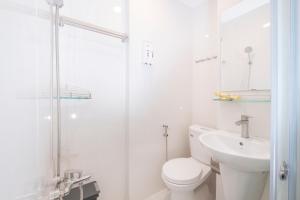 a white bathroom with a toilet and a sink at Beauty House in Ho Chi Minh City +40 photos