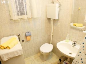 a small bathroom with a toilet and a sink at Apartments Slavko in Trogir +22 photos