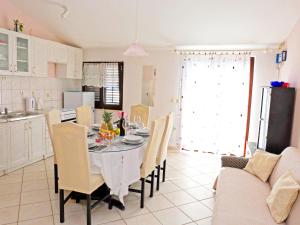 a kitchen and dining room with a table and chairs at Apartments Slavko in Trogir