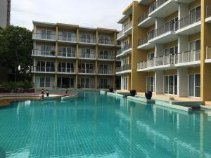 an empty swimming pool in front of a building at Seaside Apartment at Cha-Am in Cha Am
