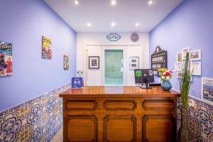 a room with a wooden desk in a room with purple walls at Casa Belmonte in Lisbon