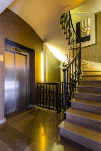 a staircase in a building with a metal door at CMG - Suite Premium Tour Eiffel - 31 in Paris