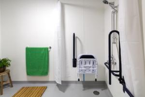 a bathroom with a shower and a green towel at Roseland House in Falmouth