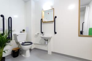 a bathroom with a toilet and a sink at Roseland House in Falmouth