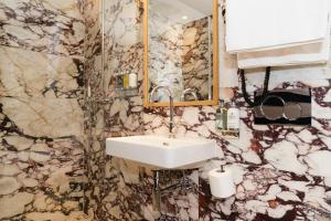 a bathroom with a sink and a mirror at Mimi's Hotel Soho in London