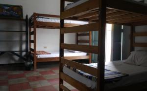 a room with three bunk beds in a room at Luna International Hostel in Estelí