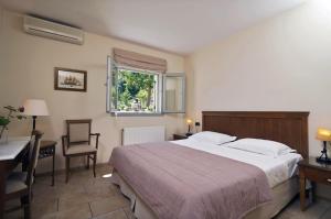 Postel nebo postele na pokoji v ubytování Harmony Hotel Apartments