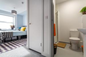 a bathroom with a bed and a sink and a toilet at Roseland House in Falmouth +81 photos