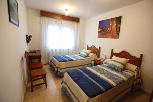 Postel nebo postele na pokoji v ubytování Hostal San Blas