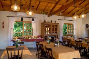 a dining room with tables and chairs and lights at Pousada Paiol in Atibaia