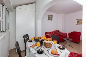 a dining room with a table with a basket of fruit at Apartment Marko Dubrovnik in Dubrovnik