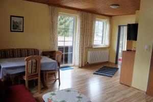 a living room with a table and chairs and a window at Ferienhaus Santner in Tamsweg