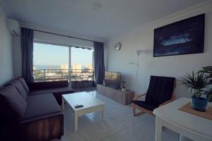 a living room with a couch and a table at Atico Nacho in Torremolinos