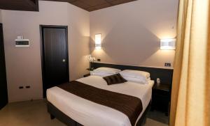 Postel nebo postele na pokoji v ubytování Hotel Mignon