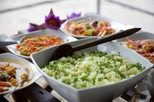 a table topped with bowls of different types of food at Bedda Eco Cottages in Deniyaya