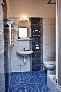 a bathroom with a sink and a toilet at Krechowiak in Augustów