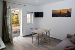 a living room with a table and a couch at La Ferme Des Barmonts in Villejuif