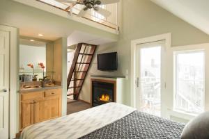 a bedroom with a bed and a fireplace at 8 Dyer Hotel in Provincetown