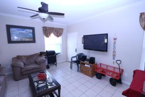 a living room with a couch and a flat screen tv at Los Cabos III Condominiums in South Padre Island