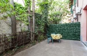a table and a chair in front of a fence at Hotel Greco in Milan