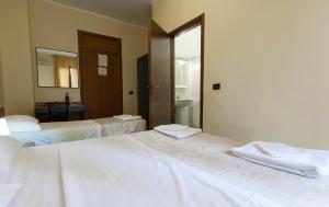 Postel nebo postele na pokoji v ubytování Hotel Greco
