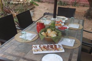 a table with plates of food on top at Chales Jack & Jill in Pipa