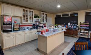 a kitchen with white cabinets and a counter top at Cherry Tree Inn & Suites in Traverse City